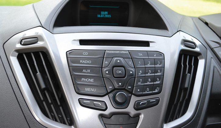 The car-like dashboard has a neat central console with a CD player and auxiliary audio input