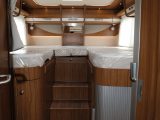 The two fixed single beds at the rear of this Hymer motorhome are accessed by three steps