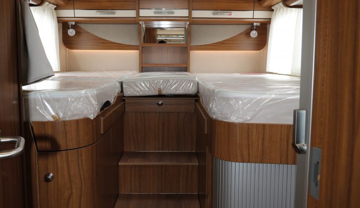 The two fixed single beds at the rear of this Hymer motorhome are accessed by three steps