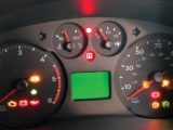 A red warning light on a motorhome dashboard
