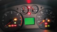 A red warning light on a motorhome dashboard