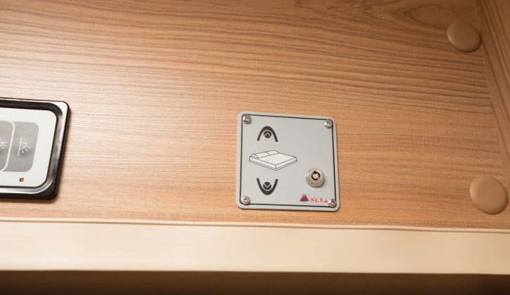 To lower the drop-down bed, insert a key into the control panel above the door, and push the ‘down’ button
