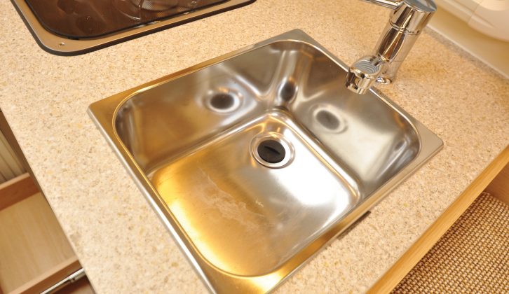 The deep stainless-steel sink has a domestic-style lever mixer tap