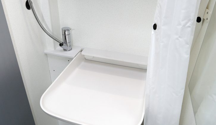 This space-saving tip-up handbasin has a drainage channel to the rear