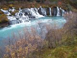 The dramatic Hraunfossar waterfalls with unbelievably blue waters await visitors to Iceland