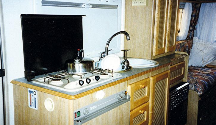 The kitchen has a two gas rings on the hob, a sink, drainer and fridge