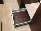 The designers have made use of floor level changes to add storage solutions, such as this large, deep drawer beneath the fridge/freezer