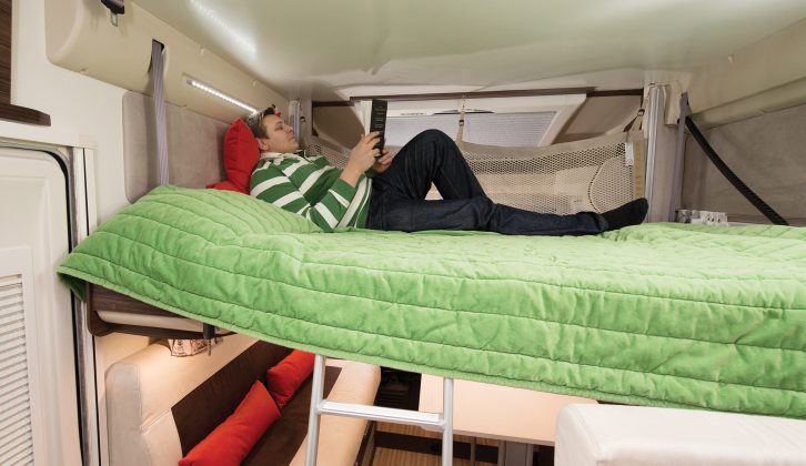 The drop-down bed can be set at half height and accessed by a ladder, as here, to accommodate a second double beneath, or lowered to the seat squabs