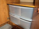 Geoff cut down a lightweight set of plastic drawers and fitted them into the base of the wardrobe to store folded garments