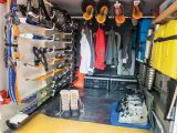 Racks secured non-invasively to the garage’s rear wall easily adapt to storing either summer or winter activity equipment