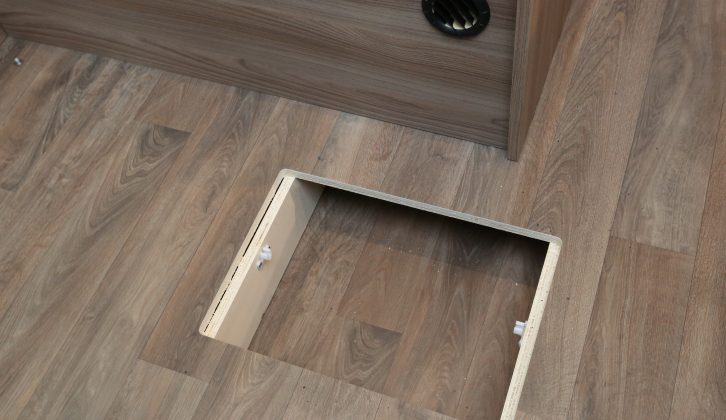 This discreet cubbie in the lounge  floor is ideal for keeping valuable items out of sight