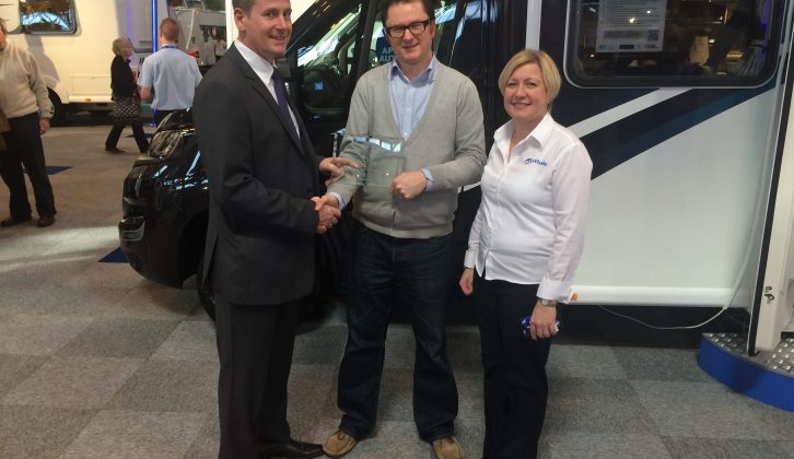 Mark Andrews, Sales Executive at Becks Motorhomes, accepts the trophy for highest-scoring supplying dealer of new motorcaravans in the Practical Motorhome Owner Satisfaction Awards 2016 from Editor Niall Hampton and Sarah Baird, RV Business Development Manager of awards sponsors Whale