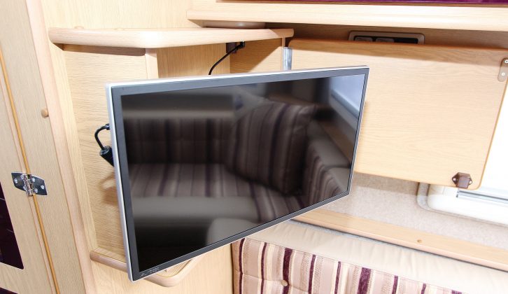 A TV cabinet includes door retainer and multi-position, extending mounting bracket. Avtex TV with sat decoder was a £510 cost option