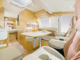 The lounge in a Hymer Exsis-i 698 features Trentino Pear cabinetwork