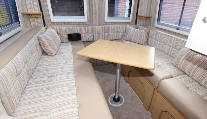 The table rotates on its single leg to facilitate easy access and comfortable dining. Note the padded blocks on the rear doors