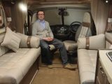 Our Editor gets comfy in the Auto-Sleeper Corinium FB's spacious front lounge – watch Practical Motorhome TV for our full review