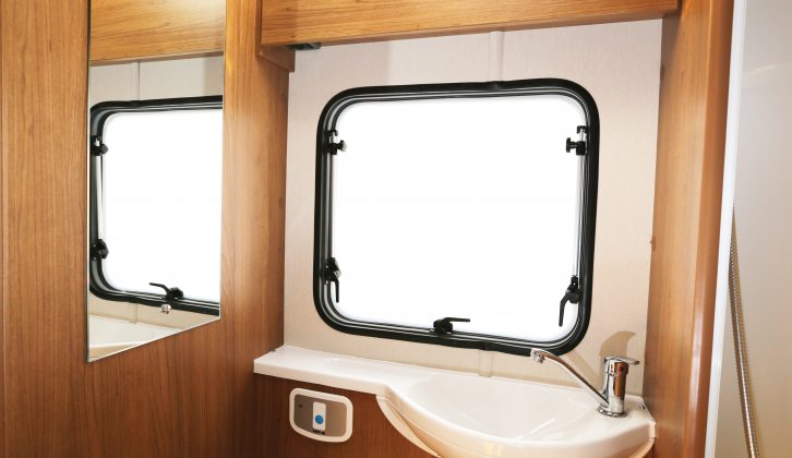 The Auto Trail Imala 730 washroom boasts an oval basin on a vanity unit, a half-length mirror and opening window, plus a fully lined shower compartment