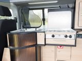 The Danbury Surf VW camper's kitchen features an extruded worktop and fridge behind the driver's seat