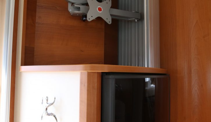 The TV mounting bracket is behind a tambour door, above the 160-litre fridge which is opposite the main kitchen area