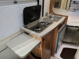 You get just two gas burners, a sink and a compressor fridge in the Pilote Foxy Van V540G, plus a useful worktop extension flap – you can glimpse the bed beyond