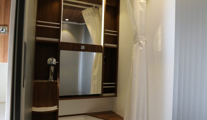The compact washroom has a smart, high-end finish, with a swivelling cassette toilet, a fold-down sink and decent storage