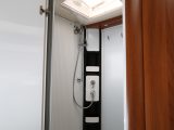 The shower tray forms the washroom floor and doors contain the spray; the retractable washing line is a thoughtful touch
