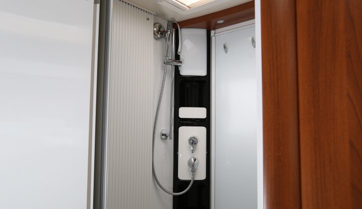 The shower tray forms the washroom floor and doors contain the spray; the retractable washing line is a thoughtful touch