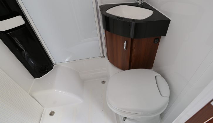 The washroom is compact, but well designed, with a swivelling cassette toilet and neat vanity unit/sink