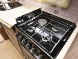 The kitchen has a three-burner gas hob and an electric hot plate, with good space around it for pan handles