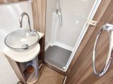 The washroom features a fully lined separate shower cubicle and a large salad-bowl style basin with chrome fittings