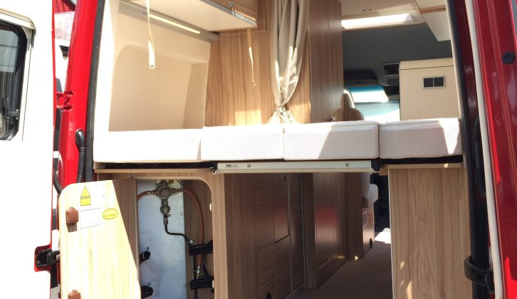There's decent storage space under the transverse double bed in this upmarket campervan