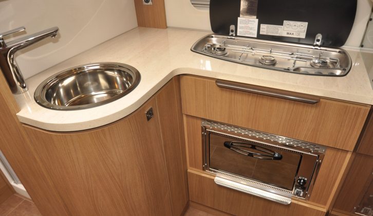 The L-shaped kitchen makes the most of the available space – three gas burners are set in a row
