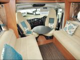 A freestanding table is one of two provided for the Auto-Trail's lounge, which has short seat benches