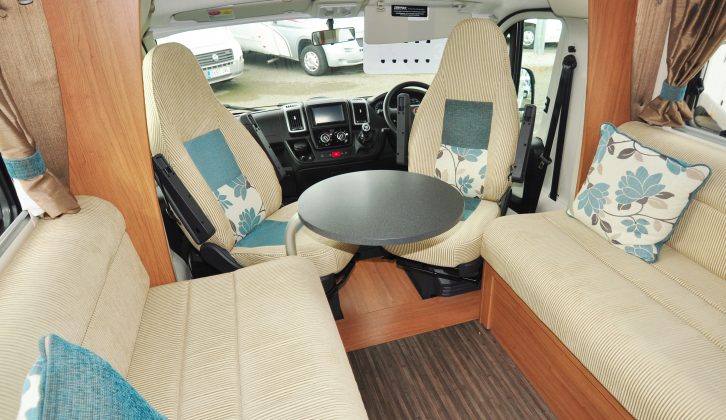 A freestanding table is one of two provided for the Auto-Trail's lounge, which has short seat benches