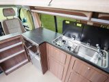 This classic campervan kitchen gives you a deep sink and a two-ring gas hob, as well as the fridge and oven/grill