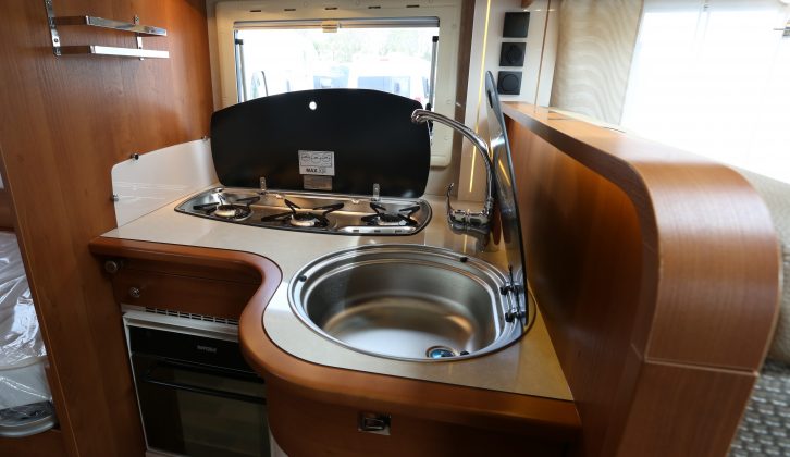 The smart, V-shaped kitchen in the Rapido 665F features maple edging, an ivory-coloured worktop and central locking
