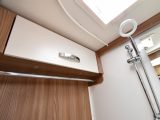 The washroom is a touch tight, but there are a few storage options, while the shower head will help make your water go further