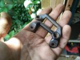 The tie-down straps loop through these two brackets, which were de-rusted, repainted and refitted