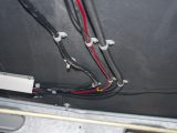 Feed the wires under the floor to the battery box, then connect brown to negative, red to positive