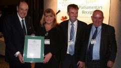Sharon and Dean Philpin are presented their certificate by the Right Honourable Sir Nicholas Soames, MP and Grenville Chamberlain, Chairman of The Caravan Club