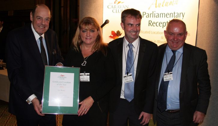 Sharon and Dean Philpin are presented their certificate by the Right Honourable Sir Nicholas Soames, MP and Grenville Chamberlain, Chairman of The Caravan Club