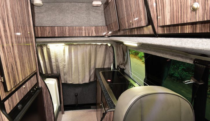 The view towards the back of the Vivante, with the rear-door curtains pulled – the wood-grain makes the interior feel a little dark