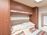 Wardrobes flank the island bed with cupboards above, LED spotlights also fitted – read more in the Practical Motorhome Elddis Encore 254 review