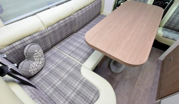 The L-shaped dinette is a great place for lounging, but it can also be converted to provide two travel seats for anyone in the back