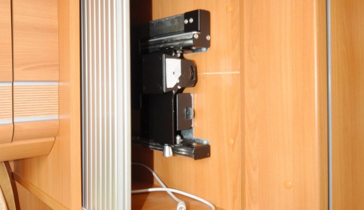 The slide-out TV bracket can be neatly hidden from view, behind a tambour door