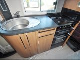 In this Auto-Trail's kitchen you get a pan store, a sink with a drainer, a microwave, overhead lockers and under-counter soft-close drawers