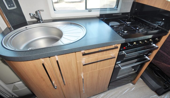 In this Auto-Trail's kitchen you get a pan store, a sink with a drainer, a microwave, overhead lockers and under-counter soft-close drawers