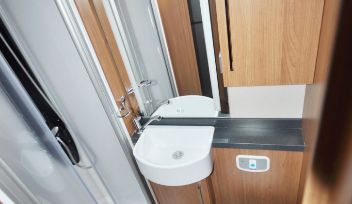 The spacious washroom gets lockers under the basin and over the toilet, but there’s no window
