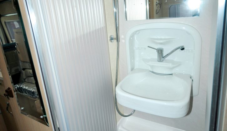 The end washroom has space for a bench toilet, as well as a separate shower cubicle with a drop-down basin