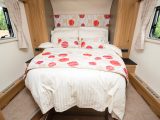 The new in-line island bed might have required a longer body length, but it is the central point of a supremely comfy room and is flanked by wardrobes